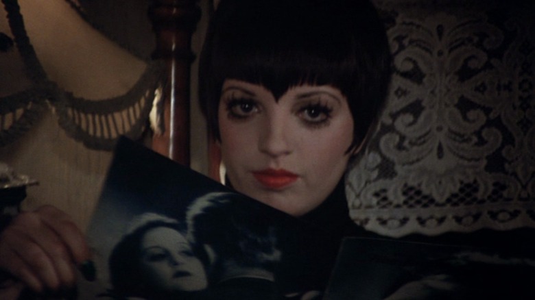 Liza Minnelli as Sally Bowles in her trademark pointed bangs, staring directly at the camera