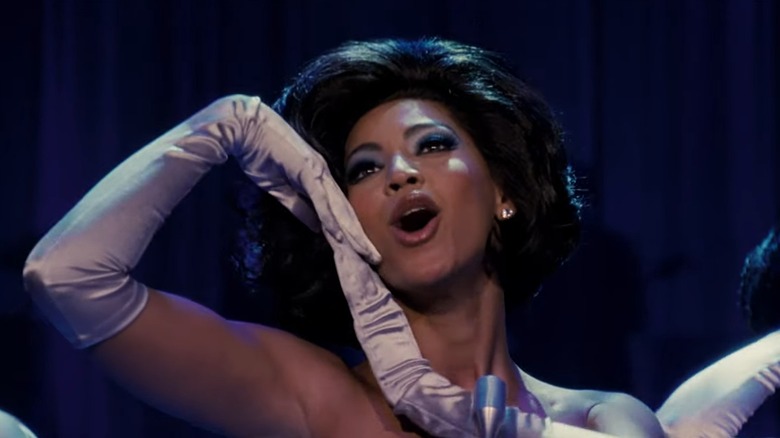 A closeup of Beyoncé as Deena Jones in Dreamgirls, resting her chin on her gloved hands