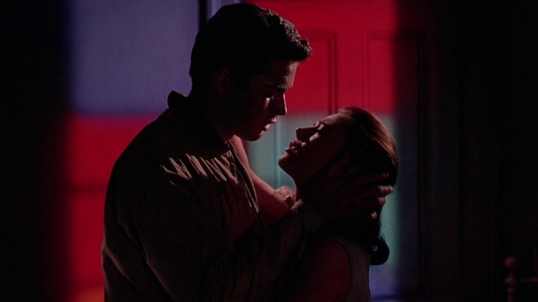 Natalie Wood and Richard Beymer as Maria and Tony in West Side Story, silhouetted against red, white, and blue lights