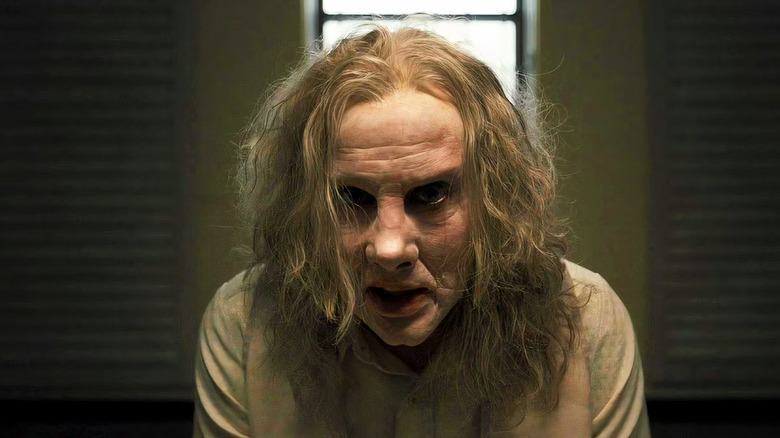 Nicolas Cage as Longlegs in Longlegs, looking fixedly into the camera.