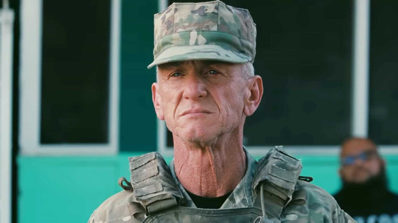 Sean Penn as Colonel Steven J. Lockjaw, in his military uniform and straining as he looks ahead.