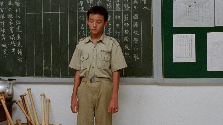 Chang Chen as Hsiao Si'r standing in front of blackboard in A Brighter Summer Day