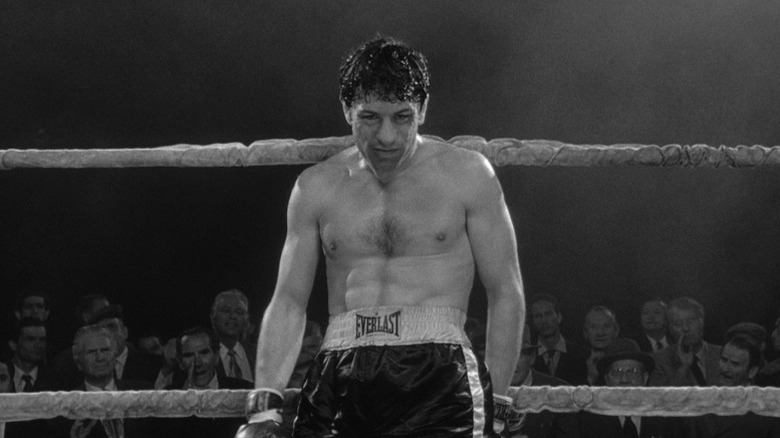 Robert De Niro as Jake LaMotta leaning against boxing ring ropes in Raging Bull