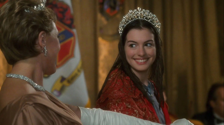 Anne Hathaway as Mia smiling with wet hair and crown looking at Julie Andrews as the queen in Princess Diaries