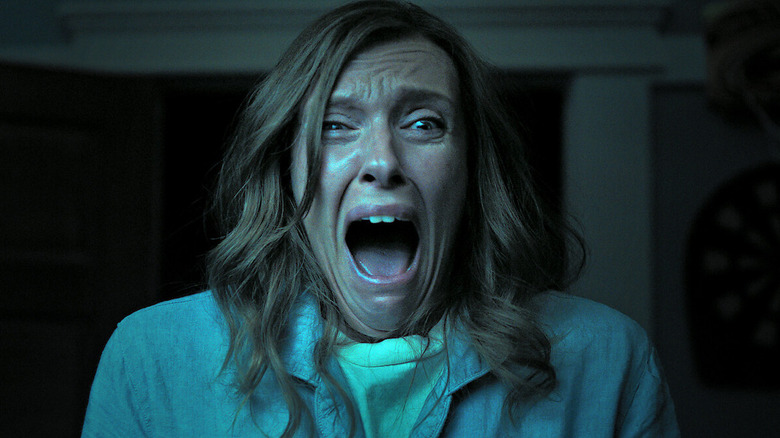 Toni Collette as Annie Graham in Hereditary, screaming at something past the camera.