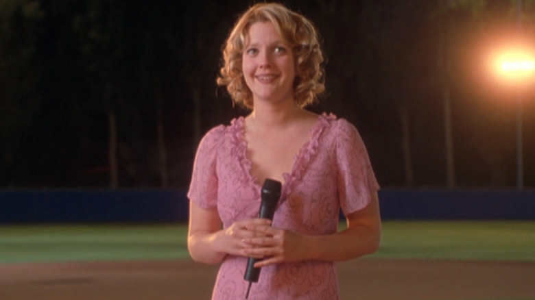 Drew Barrymore stands on a baseball diamond as Josie Geller in Never Been Kissed