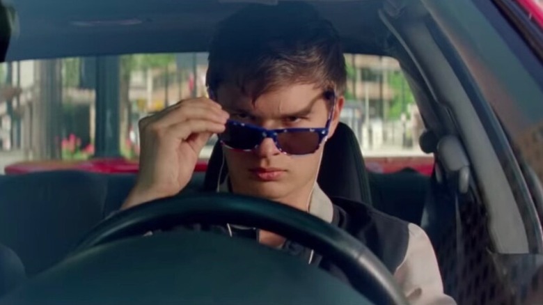 Baby (Ansel Elgort) removing sunglasses in Baby Driver