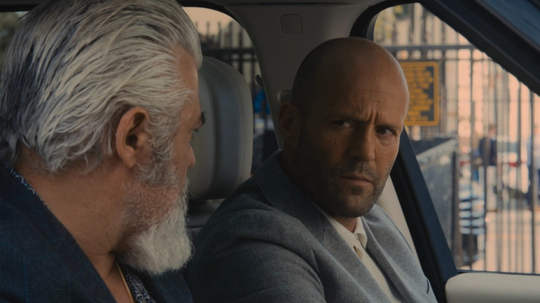 Patrick "H" Hill (Jason Statham) sitting in a car in Wrath of Man