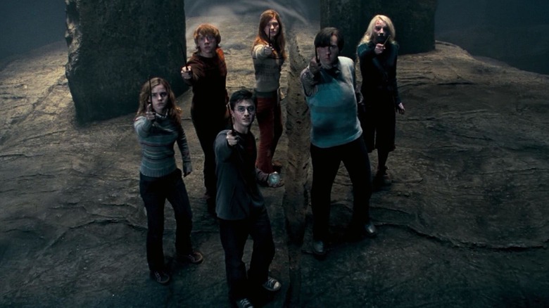 Harry Potter (Daniel Radcliffe) leads his friends in aiming their magic wands in Harry Potter and the Order of the Phoenix
