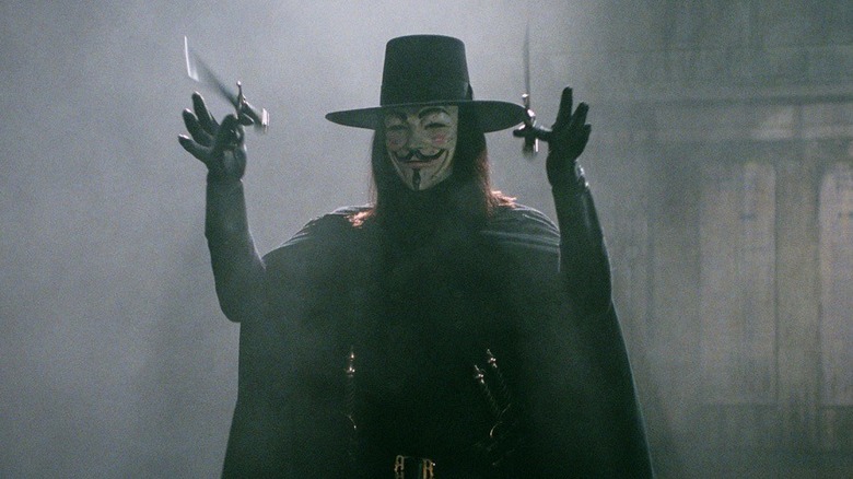 V (Hugo Weaving) tosses up two knives in V for Vendetta