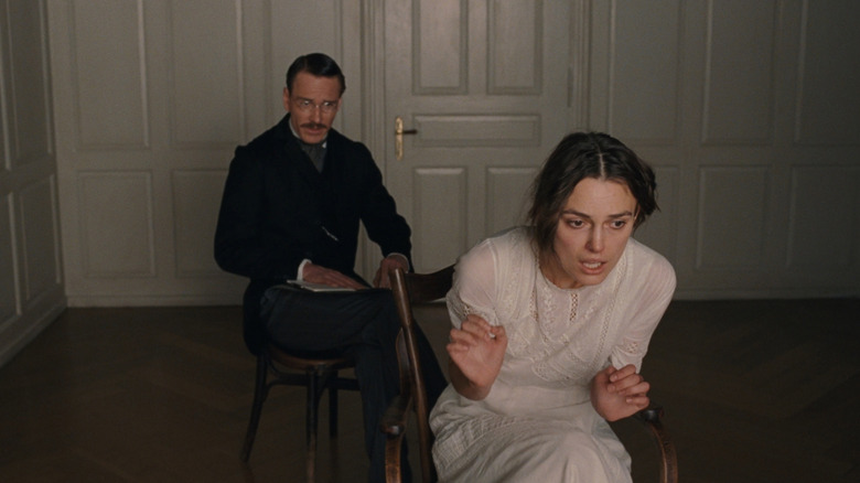 Carl Jung (Michal Fassbender) takes notes as Sabina Spielrein (Keira Knightley) sits disturbed in a chair in A Dangerous Method
