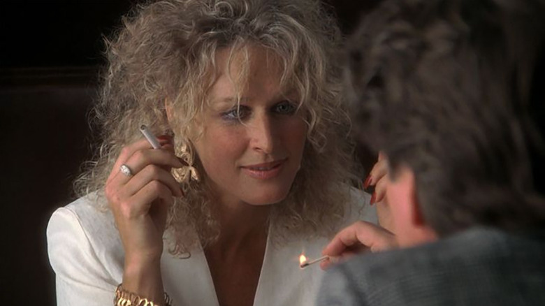 Alex Forrest (Glenn Close) waits for Dan Gallagher (Michael Douglas) to light her cigarette in Fatal Attraction
