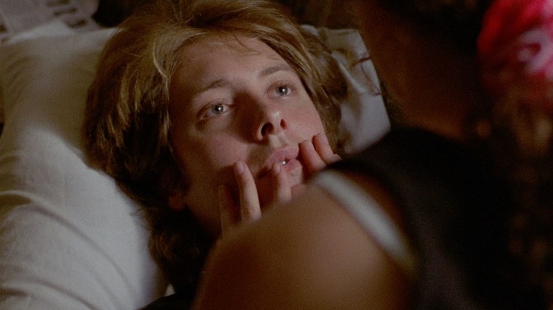 Ann Mullany (Andie MacDowell) touches the mouth of Graham Dalton (James Spader) in bed in Sex, Lies, and Videotape