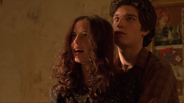 Théo (Louis Garrel) embraces Isabelle (Eva Green) from behind in The Dreamers (2003)