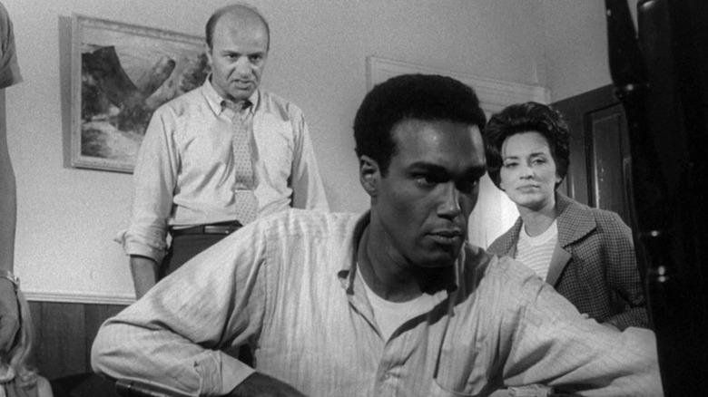 Harry Cooper (Karl Hardman), Ben (Duane Jones), and Helen Cooper (Marilyn Eastman) reckon with zombies and each other in Night of the Living Dead