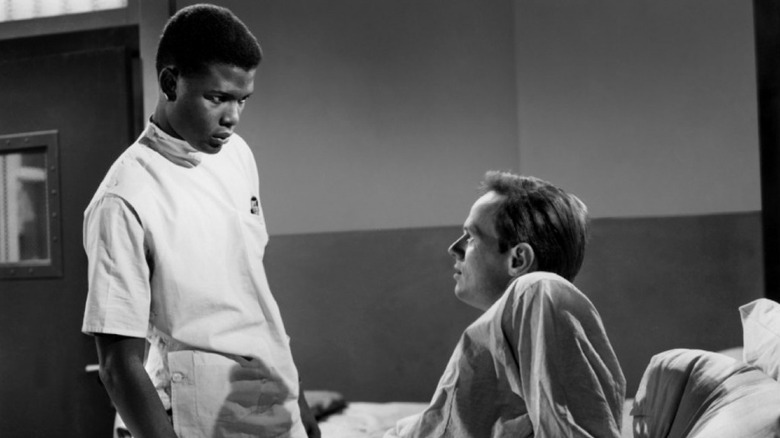 Dr. Luther Brooks (Sidney Poitier) and Ray Biddle (Richard Widmark) confront each other in No Way Out