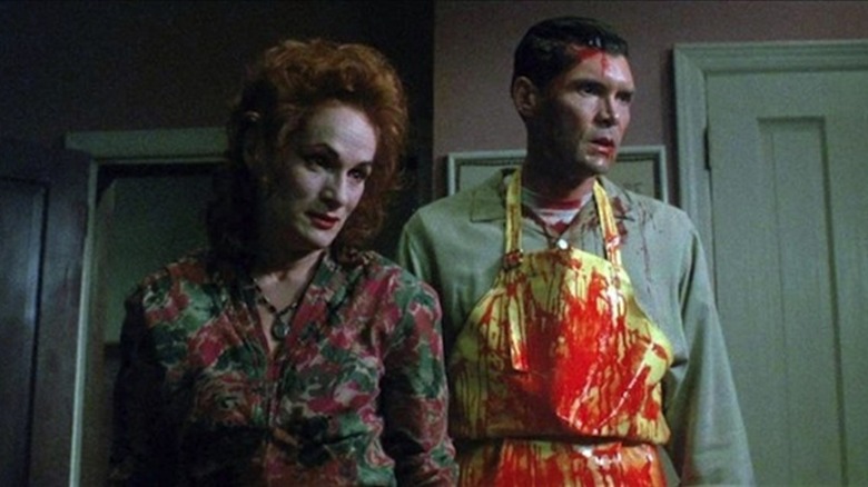 Mrs. Robeson (Wendy Robie) and Eldon Robeson (Everett McGill) look at their latest victims in The People Under the Stairs