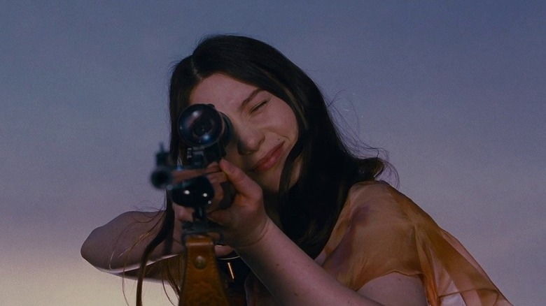 Mia Wasikowska aiming a rifle as India in Stoker