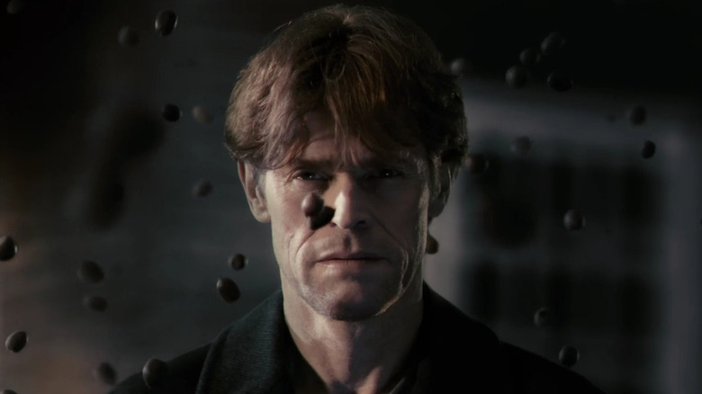 Willem Dafoe as He, looking at black ink