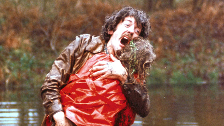 Donald Sutherland as John Baxter, holding his child and screaming in a lake in Don't Look Now