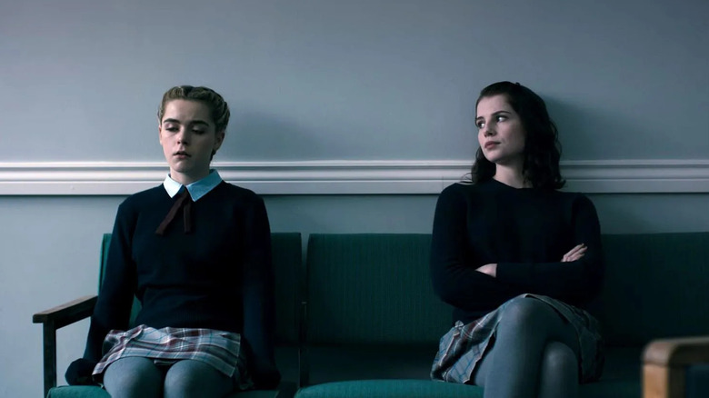Keirnan Shipka and Lucy Boynton as Katherine and Rose, sitting next to each other in The Blackcoat's Daughter