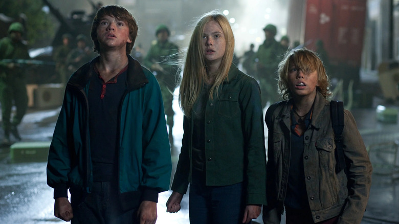 Joel Courtney as Joe stands next to Elle Fanning as Alice and Ryan Lee as Cary in Super 8