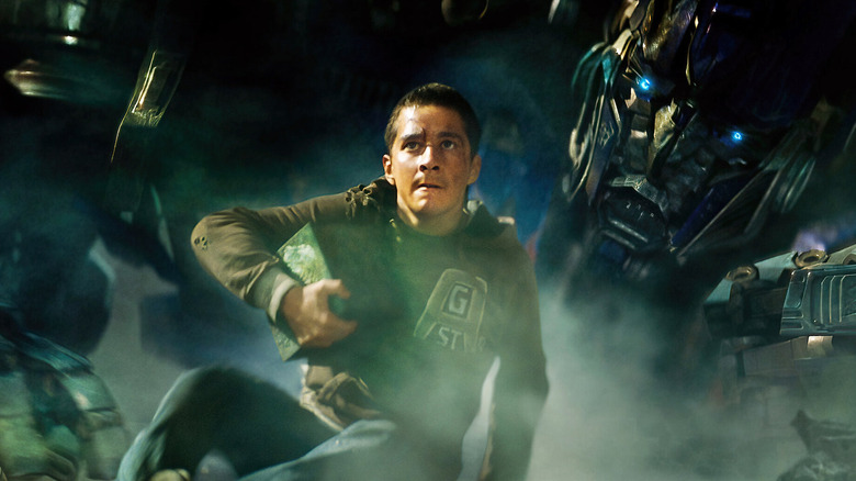 Shia LeBeouf as Sam Witwicky sits in front of Peter Cullen as Optimus Prime in Transformers