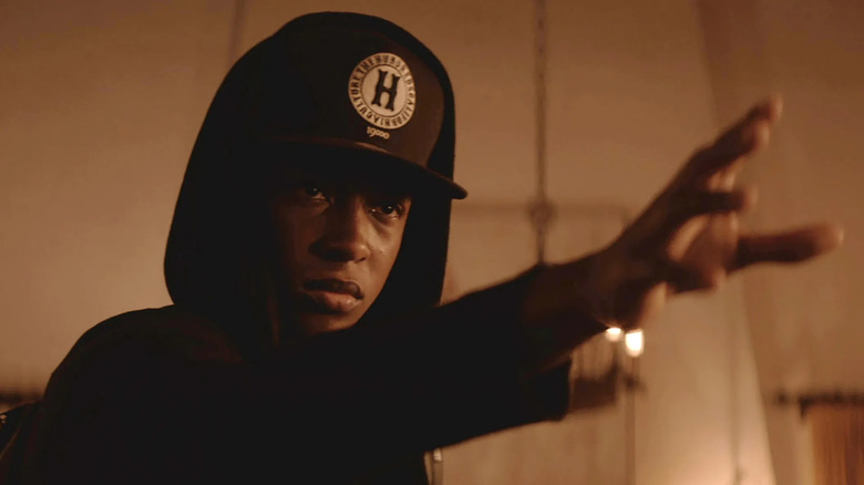 Jacob Lattimore as Bo, raising his hand in Sleight