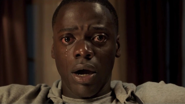 Chris Washington (Daniel Kaluuya) cries while seated in Get Out