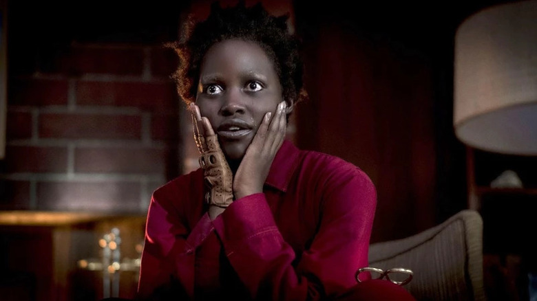 Red (Lupita Nyong'o) puts her face in her hands in Us