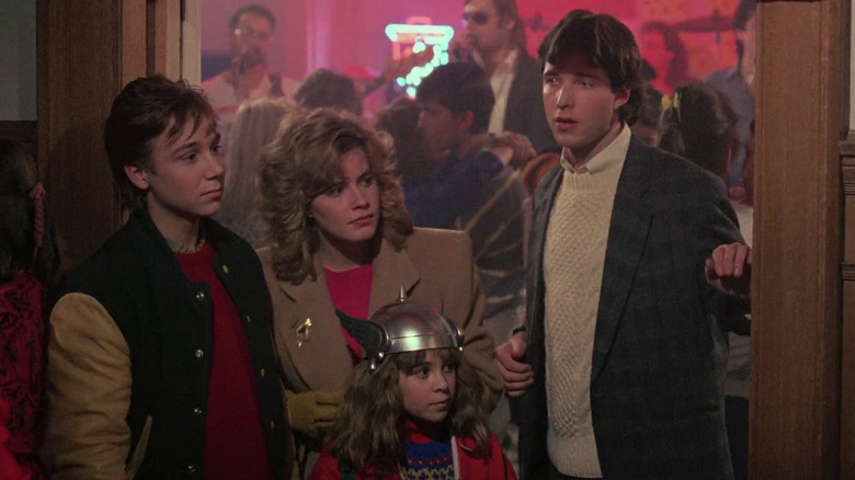 Brad (Keith Coogan), Chris (Elisabeth Shue), Sara (Maia Brewton), and Dan (George Newbern) at a party in Adventures in Babysitting