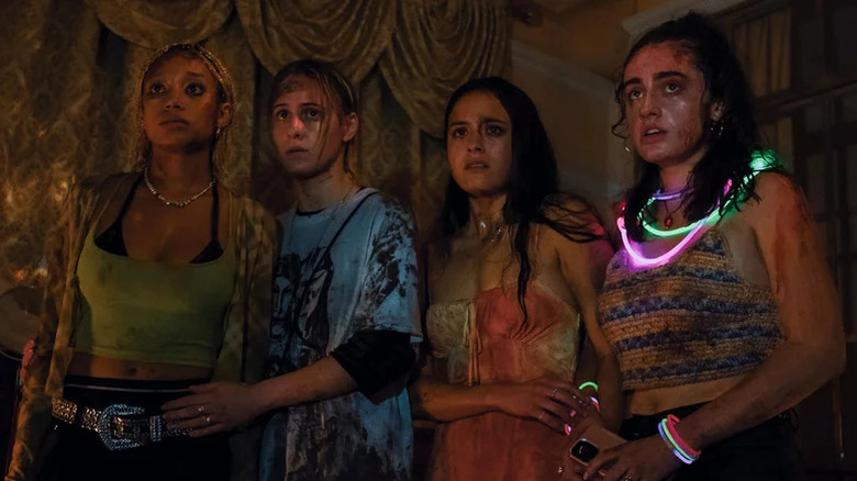 Amandla Stenberg as Sophie, Maria Bakalova as Bee, Chase Sui Wonders as Emma, and Rachel Sennott as Alice all looking sweaty, bloody, and scared in Bodies Bodies Bodies