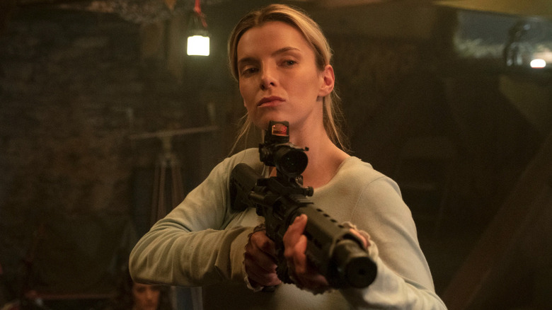 Betty Gilpin as Crystal holding a gun in The Hunt