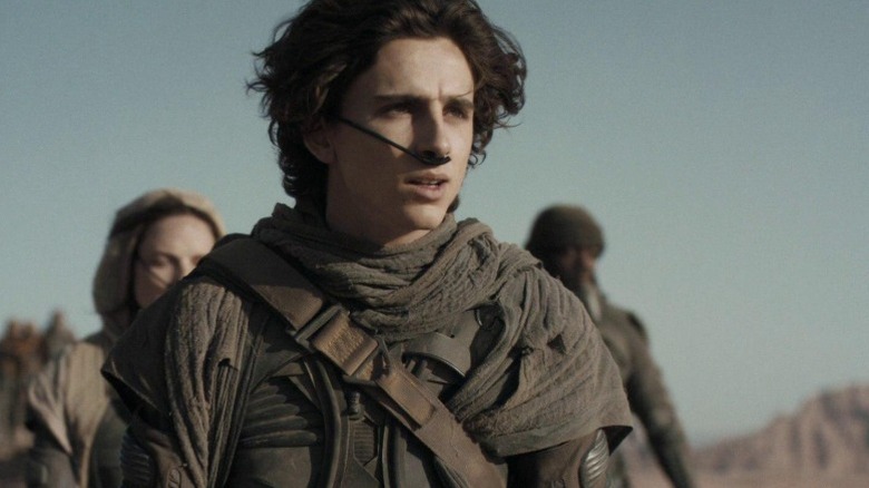 Timothée Chalamet as Paul Atreides looks over the sand dunes in Dune