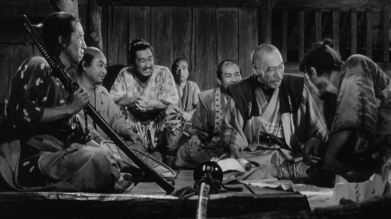 The seven samurai sitting in a room in Seven Samurai