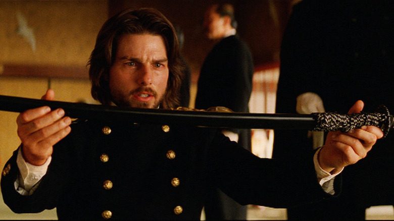 Tom Cruise as Nathan Algren holding a sword in The Last Samurai