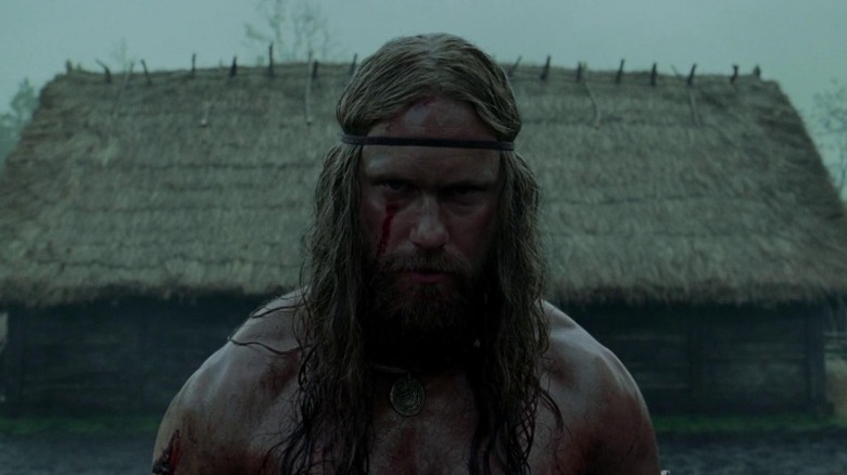 Alexander Skarsgård as Amleth angrily standing in his village in The Northman