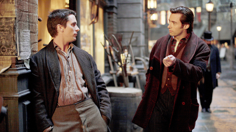 Christian Bale and Hugh Jackman as Borden and Angier, walking together down a street in The Prestige
