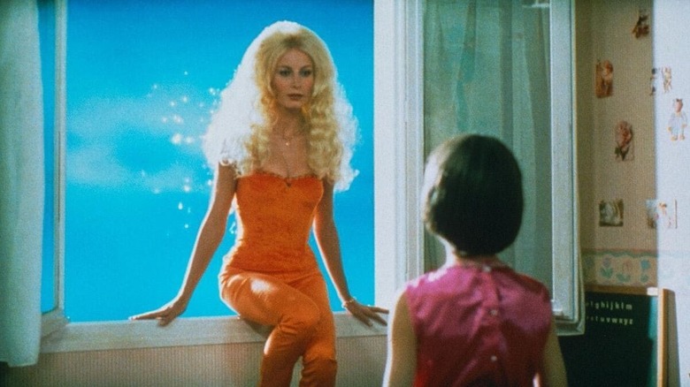 Delphine Cadet as Pam sitting on a windowsill facing Georges du Fresne as Ludo in Ma vie en rose