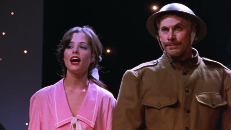 Parker Posey and Christopher Guest as Libby and Corky on stage performing Red White and Blaine in Waiting for Guffman