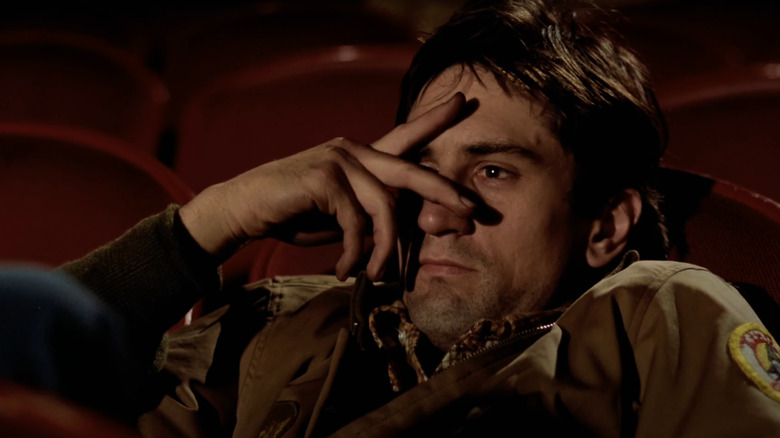 Robert De Niro as Travis Bickle covers his eyes in Taxi Driver