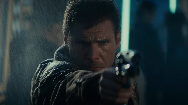 Rick Deckard (Harrison Ford) points a gun in Blade Runner
