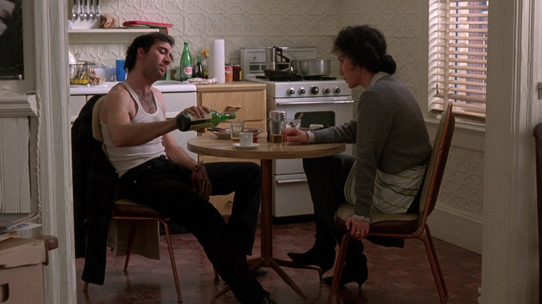 Ronny (Nicolas Cage) drinks wine with Loretta (Cher) in an apartment kitchen in Moonstruck