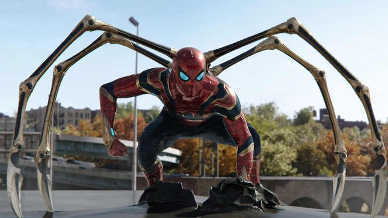 Tom Holland's Spider-Man perched on top of a car in his Iron Spider suit in Spider-Man: No Way Home.