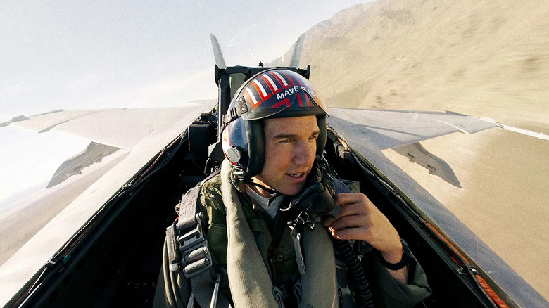 Tom Cruise as Captain Pete "Maverick" Mitchell, flying a jet in Top Gun: Maverick.