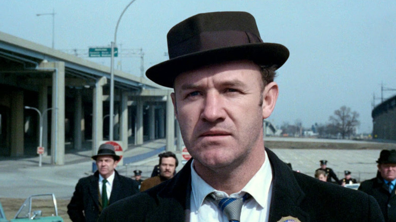 Popeye Doyle (Gene Hackman) stands in front of a police blockade in The French Connection