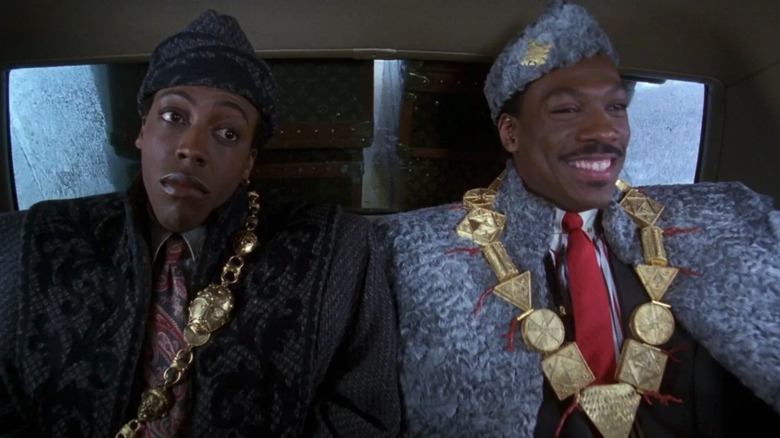 Eddie Murphy as Prince Akeem and Arsenio Hall as Semmi sitting in a taxi in Coming to America