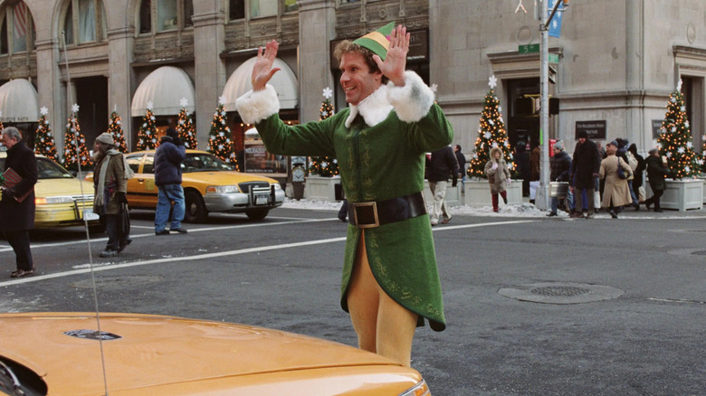 Will Ferrell as Buddy the Elf standing in front of a taxi in Elf