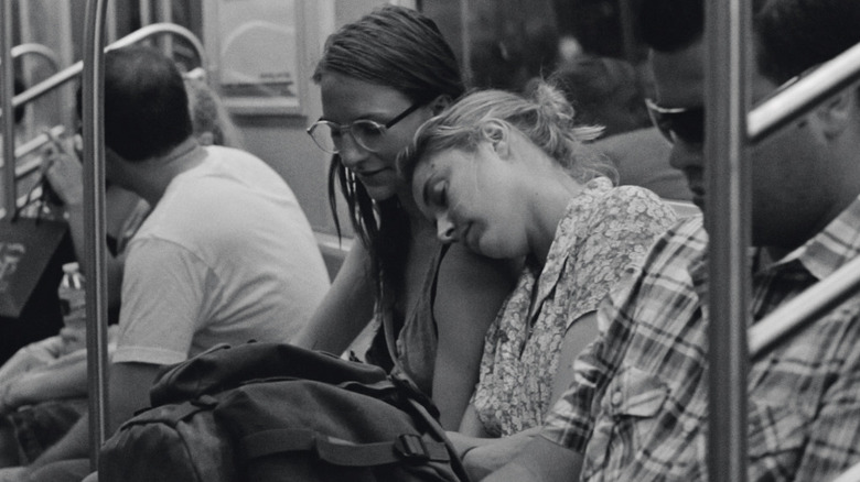 Greta Gerwig as Frances resting her head against Mickey Summer as Sophie on a subway train in Frances Ha