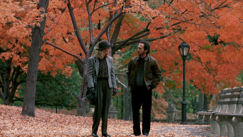 Meg Ryan and Billy Crystal as Sally and Harry walking through a park in the fall in When Harry Met Sally